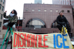 Protesters block traffic while displaying a sign in the #StopTheRaids demonstration on February 15, 2016, in Chicago, Illinois. (Photo: Tom Callahan)
