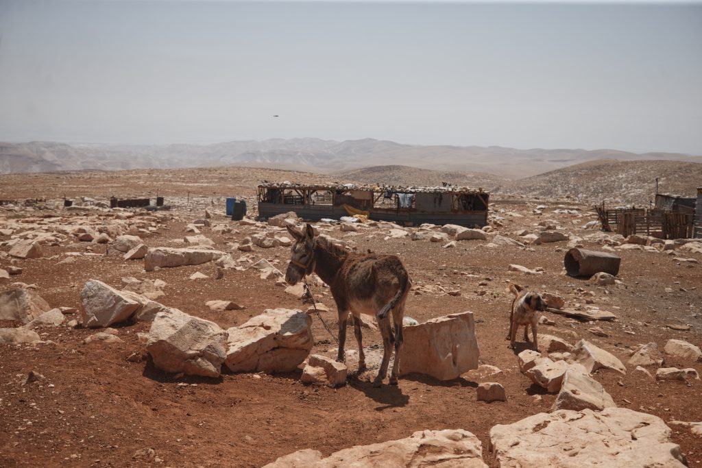 Palestinian residents of the Maghayer al-Deir Bedouin community pack their belongings as they leave following repeated attacks and harassment by Israeli settlers, in Al Mughayyir, West Bank, on May 22, 2025. On Sunday, a new Israeli outpost was established inside the community, escalating the situation. Settlers have reportedly stolen water sources, blocked access to wells, and prevented Palestinian shepherds from watering their livestock a tactic locals describe as part of a broader effort to force them off their land. (Photo: Wahaj Bani Moufleh)