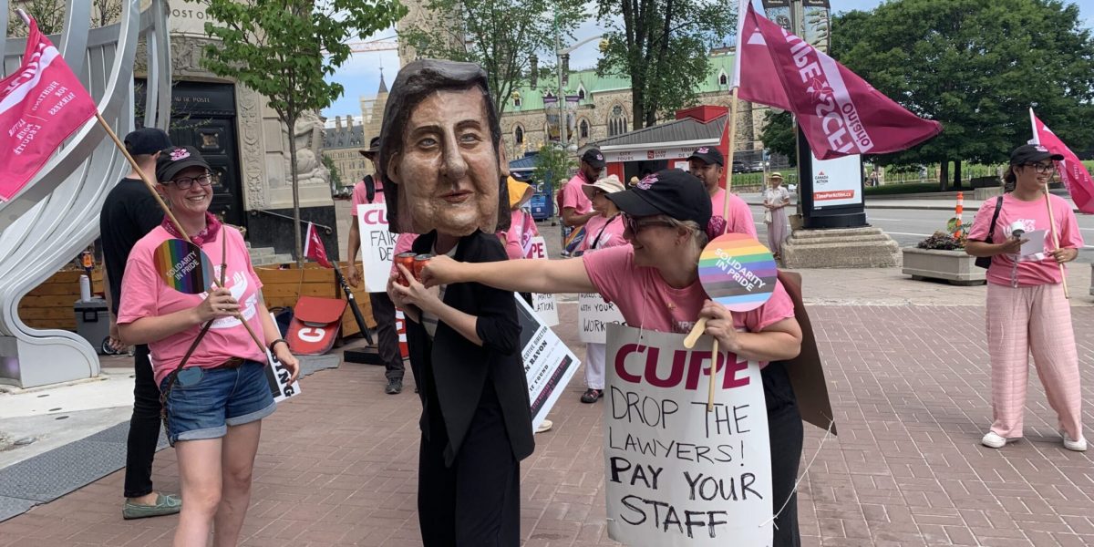 Striking Oxfam Workers Stage ‘Big Head' Action